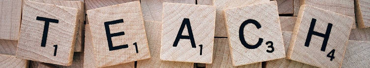 Wooden letter tiles spelling TEACH