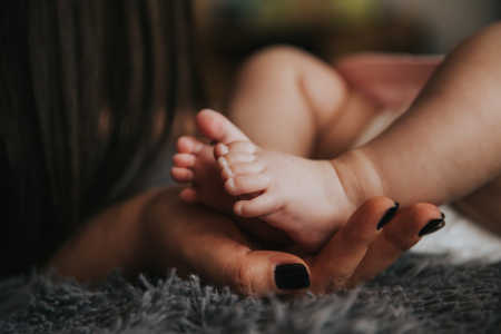 Baby feet in mother's hand